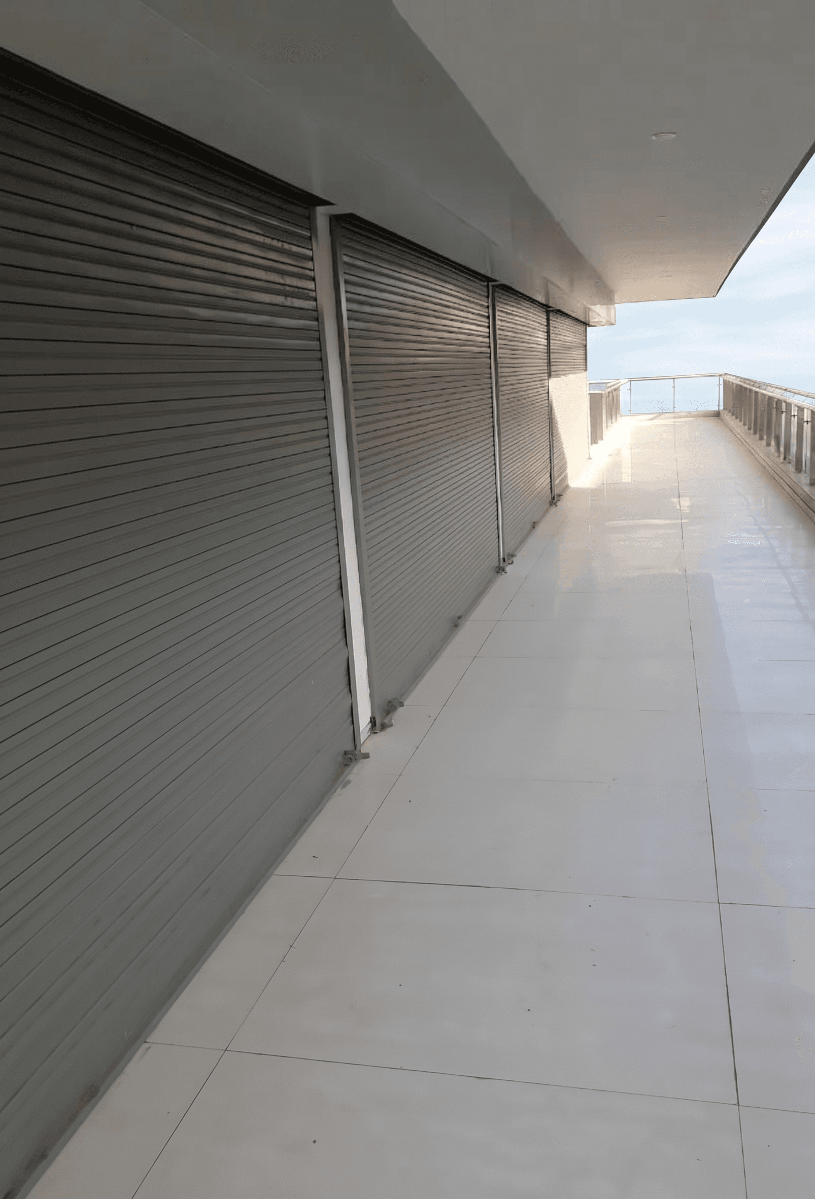 insulated industrial sectional garage doors for a commercial automotive workshop with large glass panels